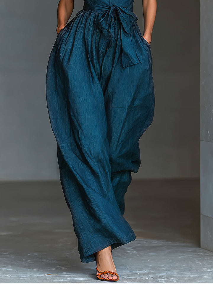 Selene | Tuta blu navy con scollo halter incrociato e gamba ampia